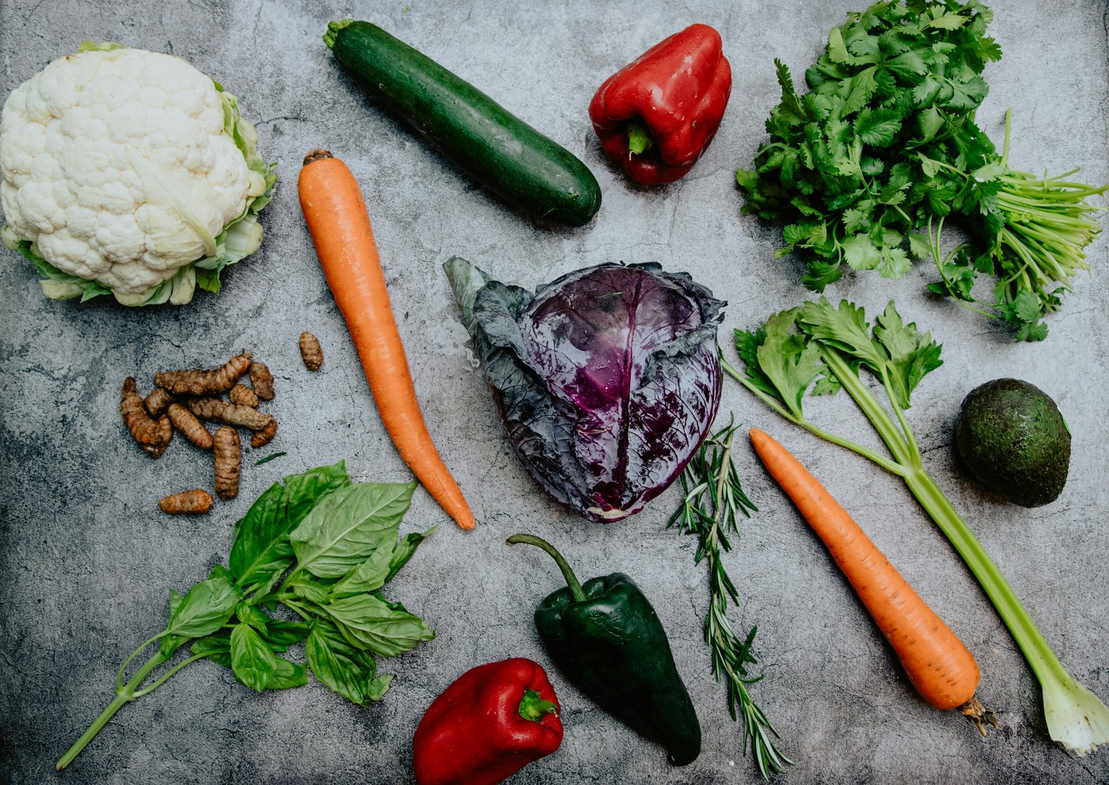 Fresh carrots, red peppers, leafy herbs, cabbage and other vibrant vegetables